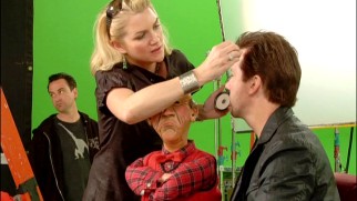 Walter gets between a make-up artist and Jeff Dunham during the filming of their green screen sleigh ride cold open.