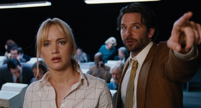 QVC President Neil Walker (Bradley Cooper) points out to Joy (Jennifer Lawrence) where the sales numbers are tracked on a marquee near the shopping network's set.
