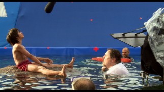 Jon Favreau gets in the water to help Neel Sethi sing "The Bare Necessities" atop a Baloo stand-in in "I Am Mowgli."