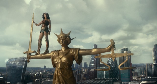 Wonder Woman stands tall on the arm of...Justice.