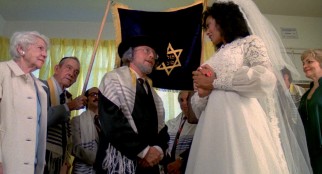 An Hasidic Jew rabbi (Saul Kahan) marries a butt-kicking black woman (Marilyn Joi) in the "Cleopatra Schwartz" trailer.