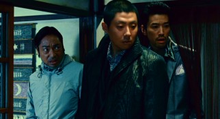 Gangster Kudo (Yoshiyoshi Arakawa) poses danger for the real Kondo (Teruyuki Kagawa, left) and the fake one too.