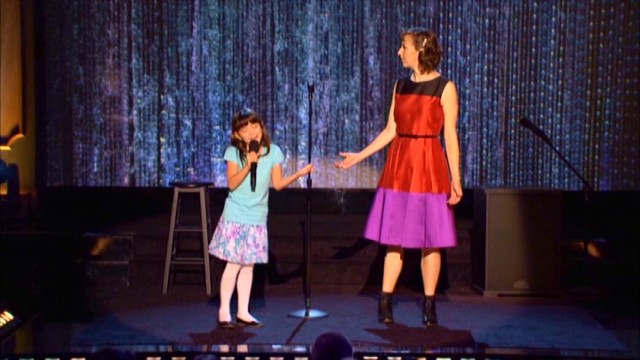 A young heckler (Chloe Noelle) crashes the stage and shows Kristen Schaal how to do stand-up comedy in the surreal second half of "Live at the Fillmore."