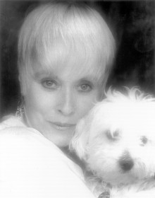 Lisa Davis, the voice and reference model for Anita in "101 Dalmatians" appears alongside a dog in a current headshot.