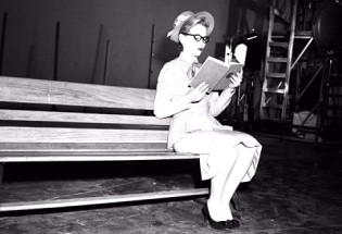 Lisa Davis strikes a reading on bench pose for animators' reference, as seen in this still from the 101 Dalmatians: Platinum Edition DVD's galleries.