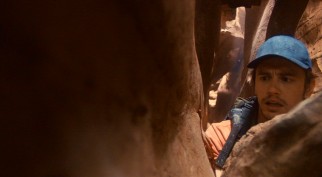 Sixteen minutes into the film, solo canyoneer Aron Ralston (James Franco) finds himself stuck between a rock and hard place.