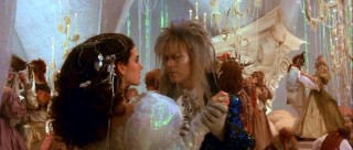 Sarah and Jareth share a dance in a glitzy '80s fantasy style ballroom sequence.