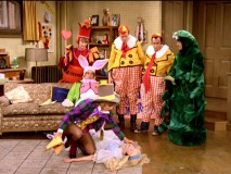 The Milwaukeean residents of Wonderland look on as a leggier-than-usual Mad Hatter tries to alert Alice.