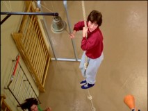 Shirley is not very comfortable climbing up a gym rope in "The Obstacle Course."