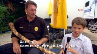 Warren doesn't use that stick to protect Miley Cyrus, it's just his way of expressing himself artistically, or so he tells Bobby Coleman.