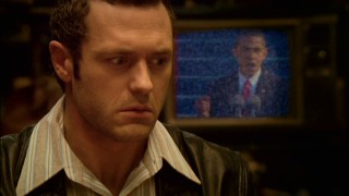 Sam (Jason O'Mara) perks up as the TV behind him shows a bit of Nobel Peace Prize winner Barack Obama's presidential inauguration, one of many 2009 things Sam is missing.