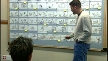 Dean DeBlois keeps things casual with a hand in the pocket while pitching a sequence with storyboards.