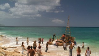 The other forty-odd survivors wave goodbye as the four rafters begin their ambiguous journey.