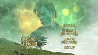 Richard is superimposed over the barrier that separates Hartland from the rest of the world on Disc One's main menu.