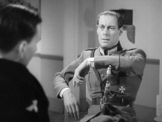 The monocle may seem a bit much, but Gus Bennett a.k.a. Dicky Randall (Rex Harrison) has no trouble convincing people that he's high-ranking Nazi official Ulrich Herzoff.