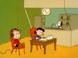 Linus takes questions on a call-in radio show moderated by Lucy and technically facilitated by Snoopy.