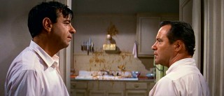 Oscar (Walter Matthau) and Felix (Jack Lemmon) stare each other down, as one source of contention (a strewn plate of spaghetti -- er, linguini) stands between them on the wall.