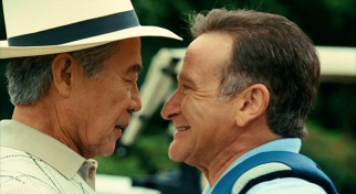 With his depth perception gone as a side effect of mistaken medication, Dan (Robin Williams) gets very close to greet Mr. Nishamura (Saburo Shimono). Oh for silly!