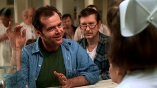 McMurphy (Jack Nicholson) objects to taking an unidentified pill while dirtying the glass with his hand.