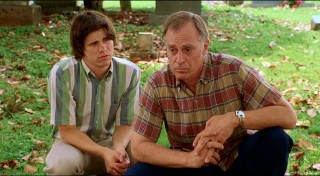 The older brother from "Joan of Arcadia" and the father from "Andre" share an uneasy moment at the cemetery.