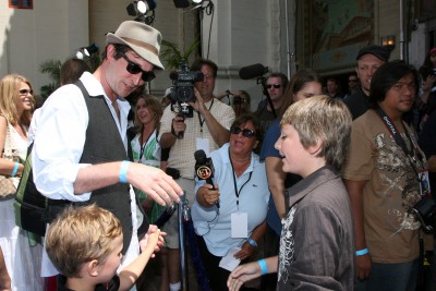 Noah Wyle oversees a hand-shaking with Parker Goris (voice of Flounder).