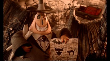 Still from The Nightmare Before Christmas: 2008 Collector's Edition DVD - click to view screencap in full 720 x 480. Halloween Town's two-faced Mayor excitedly holds his plans for next Halloween.