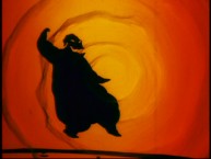 A silhouetted Oogie Boogie dances against a swirling orange background in one of the shorter deleted scenes.