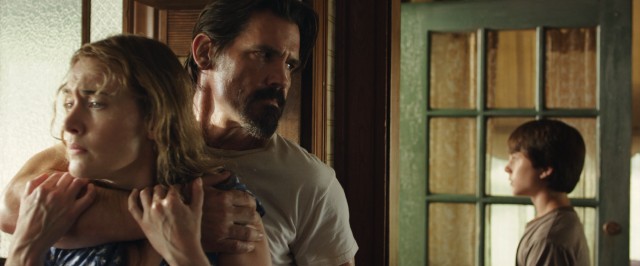Escaped convict Frank Chambers (Josh Brolin) grabs hold of Adele Wheeler (Kate Winslet) for appearances while her son Henry (Gattlin Griffith) fends off a neighbor in "Labor Day."