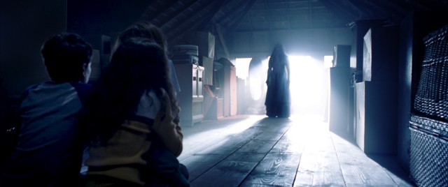 La Llorona appears in the attic before the Tate-Garcia children.