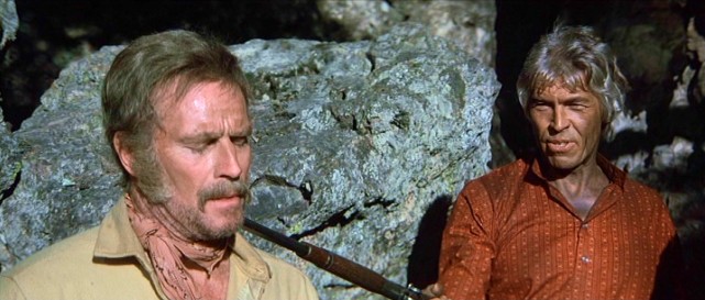 After a movie spent pursuing each other, Charlton Heston and James Coburn finally come face to face...or is that grizzly beard to shotgun barrel in "The Last Hard Men&.quot;