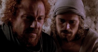 Jesus (Willem Dafoe) asks a large favor (betrayal) of his closest apostle, the curly-haired, red-bearded Judas Iscariot (Harvey Keitel).
