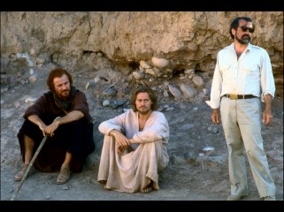 One of these men is not like the other; director Martin Scorsese is photographed next to his robed leading men Harvey Keitel and Willem Dafoe in this production still.