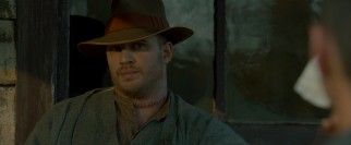 With fresh stitches in his throat, eldest brother and leader Forrest Bondurant (Tom Hardy) shoots a glare.