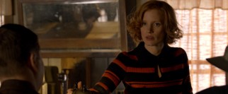 The loyal Maggie Beauford (Jessica Chastain) tends the bar out of which the Bondurants run their moonshining business.