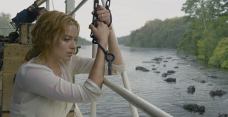 A red-haired Margot Robbie plays Jane Clayton, here seen as a damsel in distress.