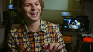 Michael Cera enjoys the minifig of his character Robin.