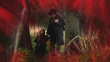 Father and daughter, Valjean and Cosette, share the screen with a red curtain in the Blu-ray's menu.
