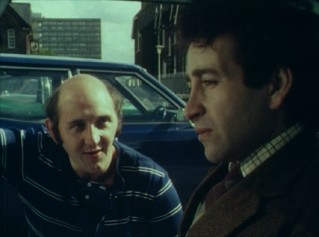A man (Robert Putt) delays his cinema-bound neighbor (Tim Stern) with small talk in the Mike Leigh Five-Minute Film "Old Chums."