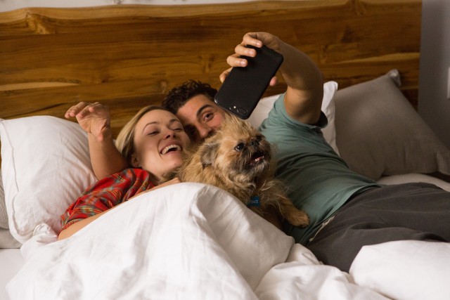 Abby (Olivia Wilde) and Will Dempsey (Oscar Isaac) are the kind of married couple that takes selfies in bed, with a profanely named dog in between them.