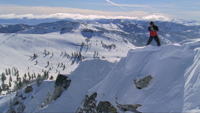 A skier checks out the view from a steep, perilous mountain in "Warren Miller's ...Like There's No Tomorrow."