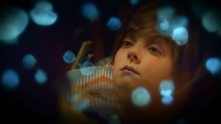 Jellyfish swim around the head of Louis Drax (Aiden Longworth) on The 9th Life of Louis Drax's Blu-ray menu.