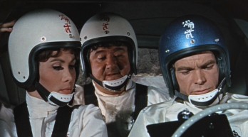 Carole (Michele Lee), Tennessee (Buddy Hackett), and Jim (Dean Jones) look over Herbie's instructions.