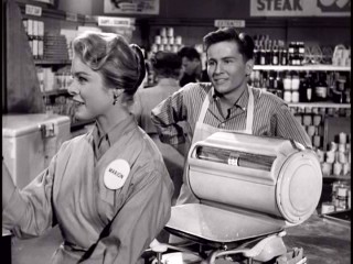 Bud Anderson (Billy Gray) has his sights set on Marion the checkout girl (Gail Land) in the "Father Knows Best" episode "Young Love."