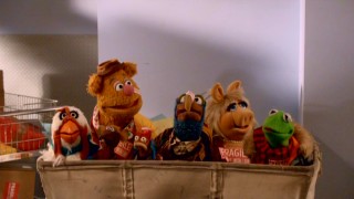 Shenanigans leave Camilla, Rizzo, Fozzie, Pepe, Gonzo, Miss Piggy, and Kermit in a mail cart in "A Muppets Christmas: Letters to Santa."