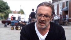 Director Nigel Cole's hair blows in the wind during his making-of featurette interview.