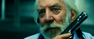 Not long for this world, Arthur's wheelchair-bound mentor Harry McKenna (Donald Sutherland) clings to his engraved favorite weapon.