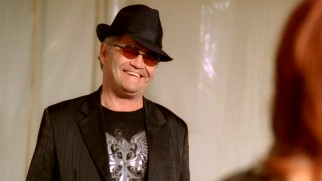 Micky Dolenz turns up as a fundraiser-performing version of himself for some Monkees jokes.