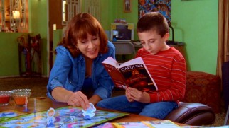 Frankie (Patricia Heaton) gives bookworm son Brick (Atticus Shaffer) a socialization hand by playing his turn for him in a playdate Chutes & Ladders game.