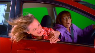 Guest starring as a motivational consultant who's only posing as a drunk potential customer, Amy Sedaris has her refreshing head out the car window green screen drive preserved as a deleted scene.