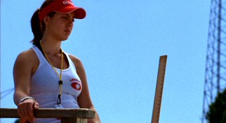 Grace Berry (Eva Amurri) carries a yardstick at her summer job as a water park lifeguard with which to ensure kids meet the water slide's minimum height requirement.